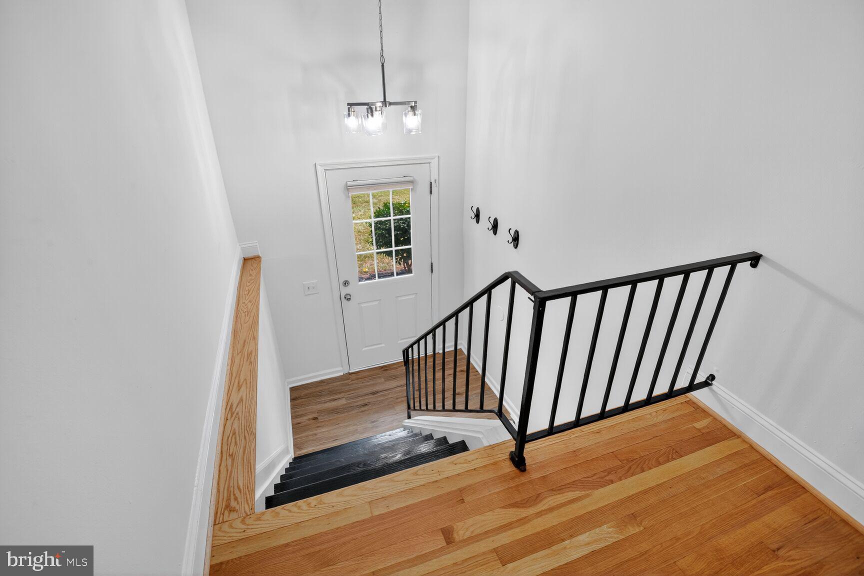 202 East Gordon Street Sterling, VA 20164 - Photo 3 of 20 a view of a hallway with wooden floor and staircase