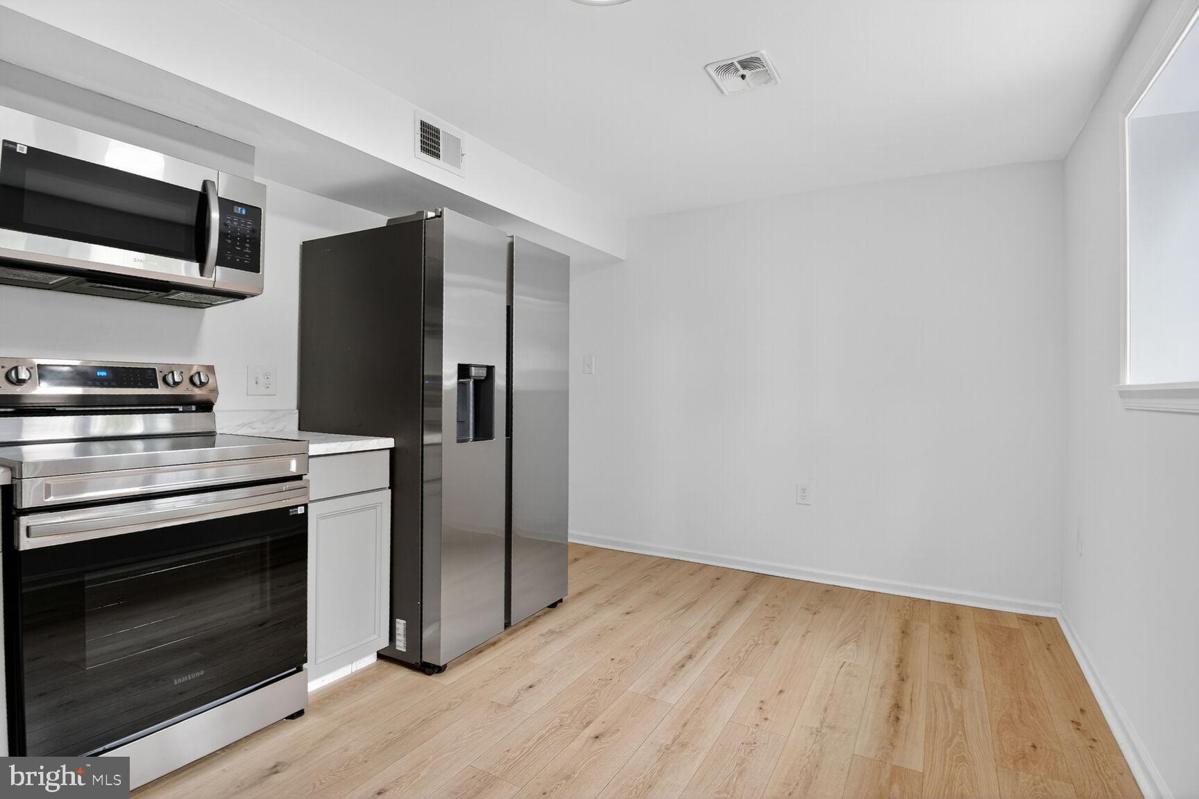 202 East Gordon Street Sterling, VA 20164 - Photo 5 of 20 a kitchen with stainless steel appliances a stove a microwave and a refrigerator