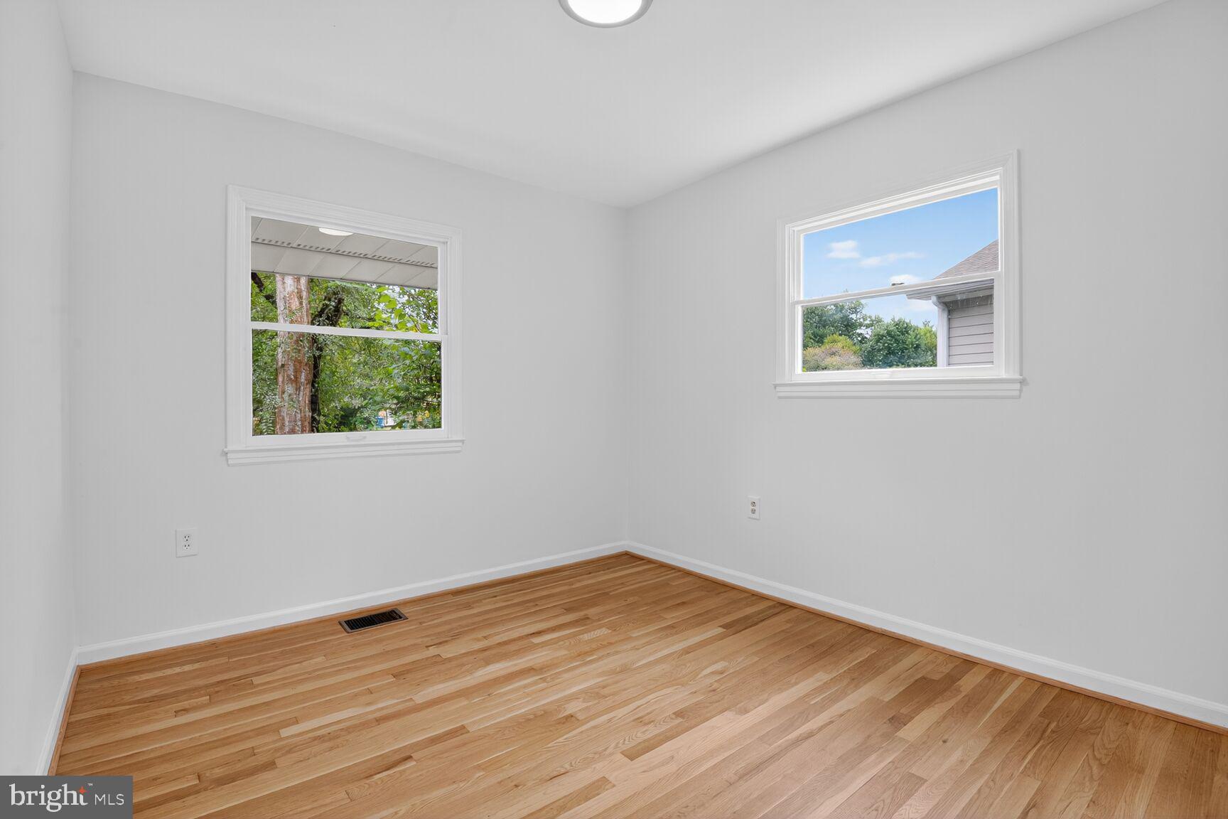 202 East Gordon Street Sterling, VA 20164 - Photo 10 of 20 a view of an empty room with wooden floor and a window