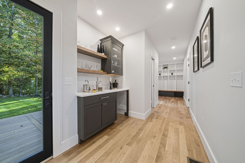 7 Ashcroft Road Sharon, MA 02067 - Photo 13 of 36 a kitchen with stainless steel appliances granite countertop a refrigerator a sink dishwasher a stove and white countertops with wooden floor