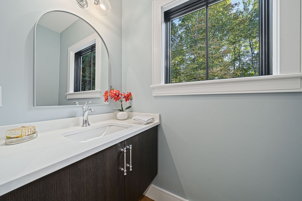 7 Ashcroft Road Sharon, MA 02067 - Photo 14 of 36 a bathroom with a sink and a mirror