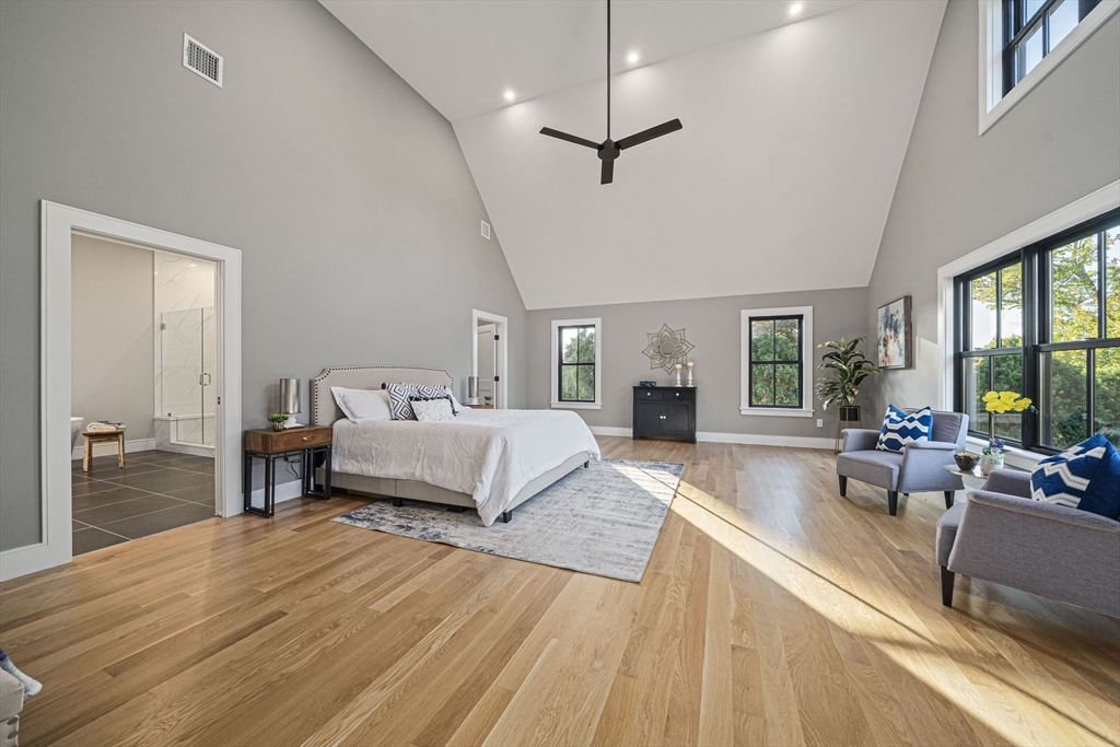 7 Ashcroft Road Sharon, MA 02067 - Photo 19 of 36 a bedroom with a large bed and a wooden floor