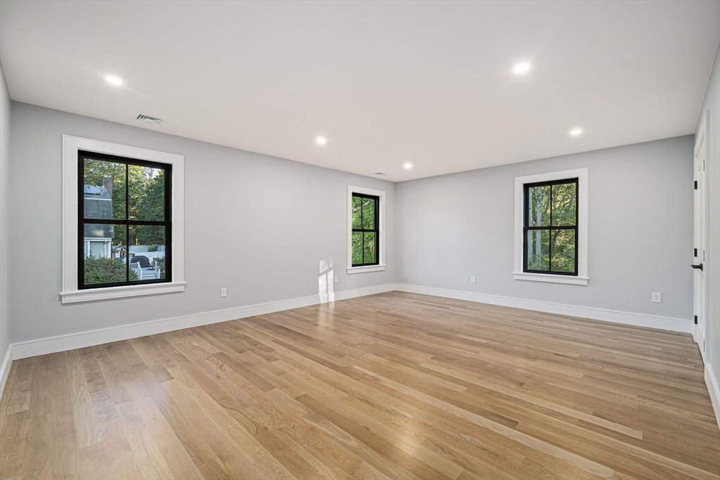7 Ashcroft Road Sharon, MA 02067 - Photo 24 of 36 an empty room with wooden floor and windows