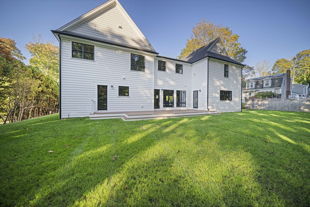 7 Ashcroft Road Sharon, MA 02067 - Photo 34 of 36 a front view of a house with a garden and yard