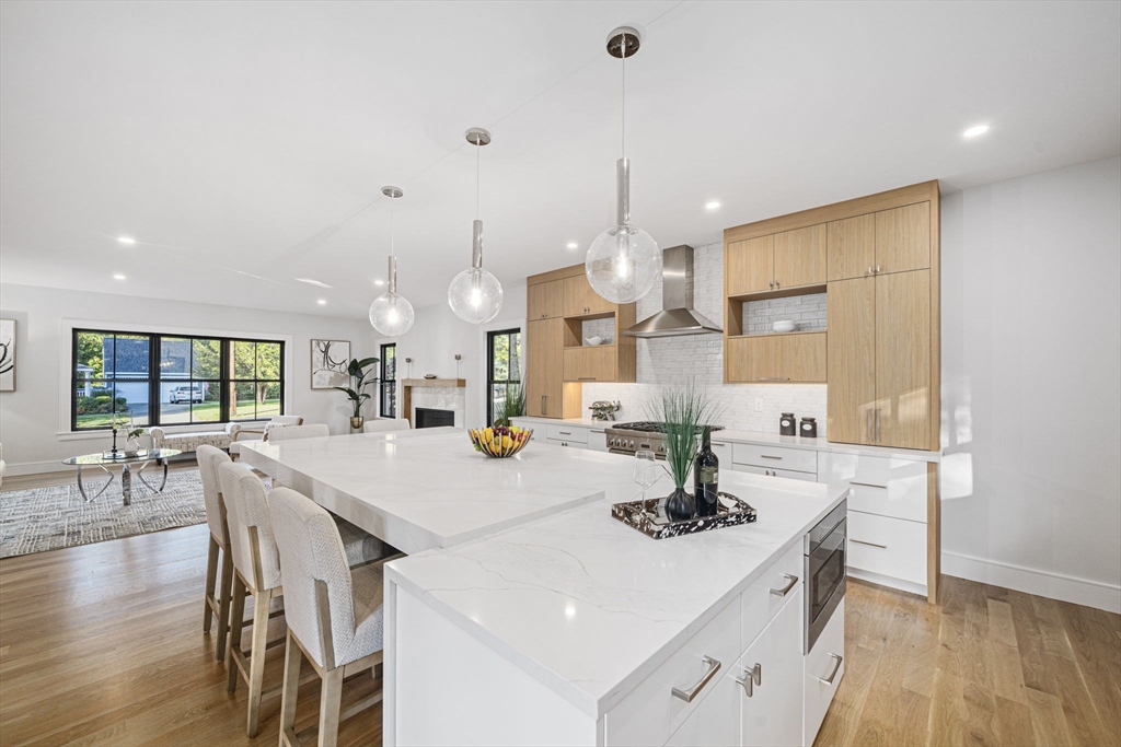 7 Ashcroft Road Sharon, MA 02067 - Photo 8 of 36 a kitchen with kitchen island a stove a table and chairs in it