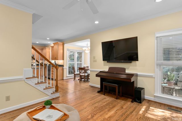 a view of a dining room with furniture wooden floor and a chandelier
