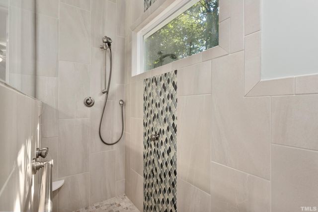 a view of walk in closet with clothes