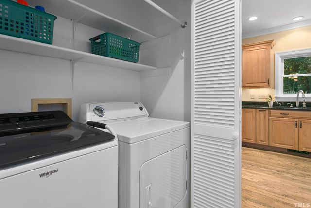 an aerial view of a house with swimming pool and large trees