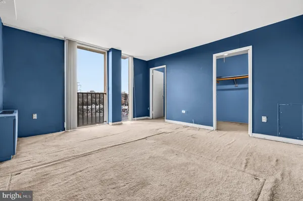a view of an empty room with a closet