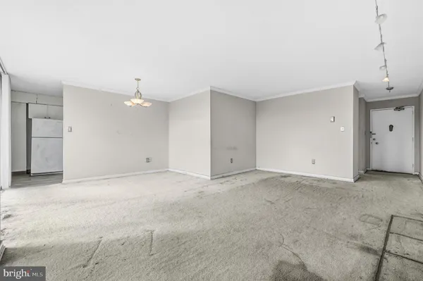 a view of an empty room with a kitchen