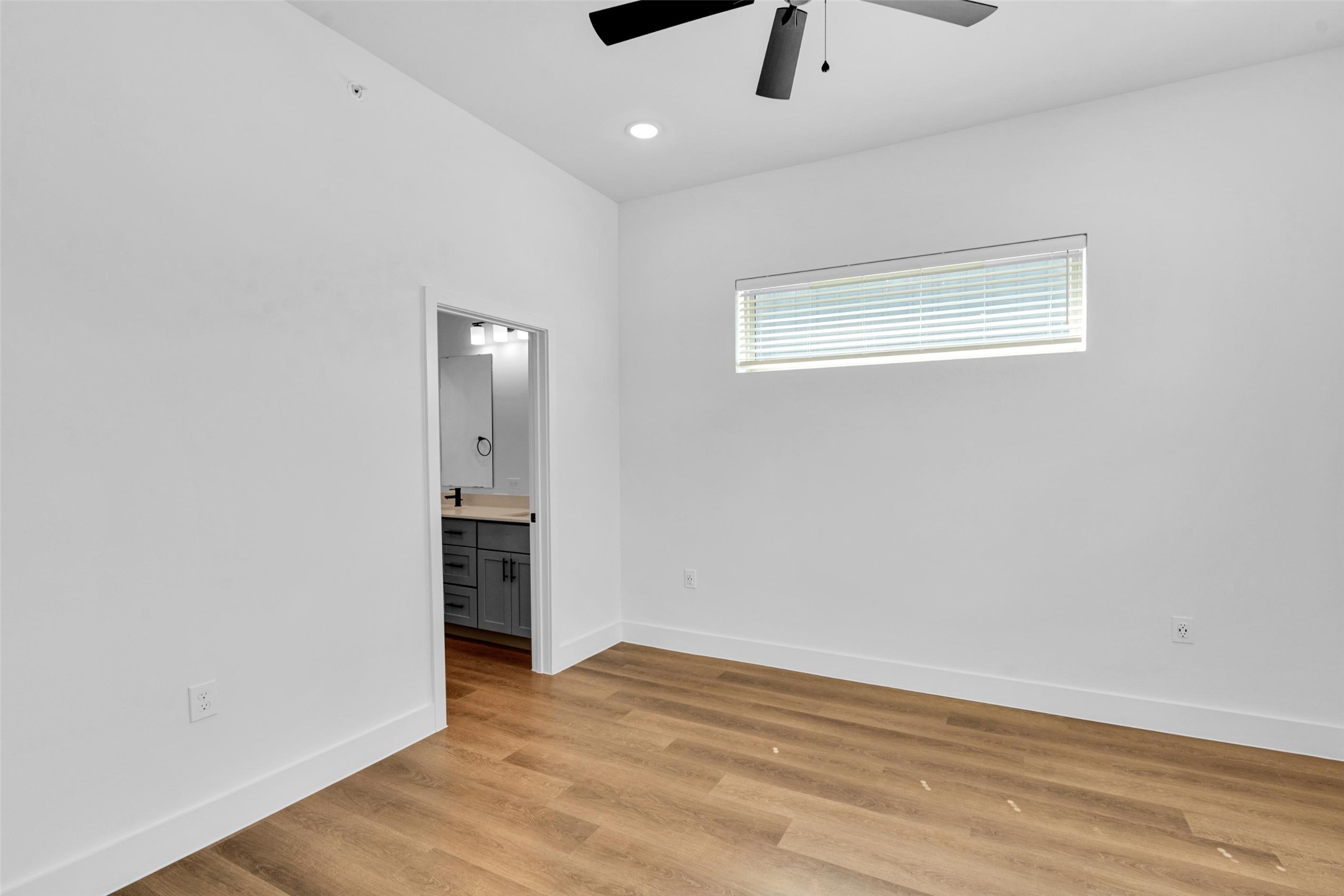 1354 A Izzy Lane Little Elm, TX 75068 - Photo 16 of 38 an empty room with wooden floor cabinet and windows