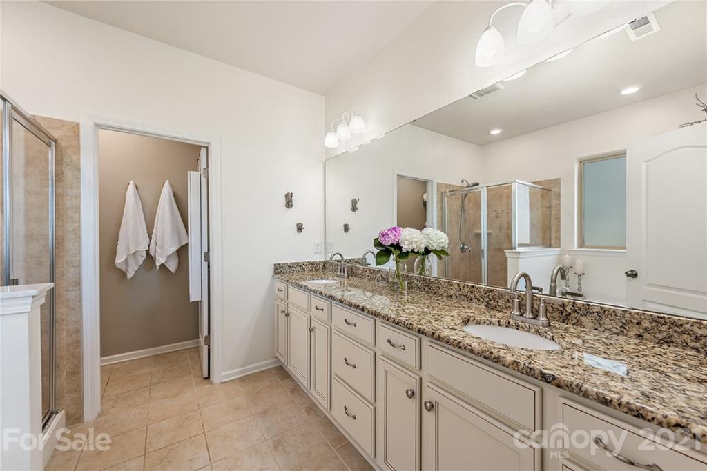 3026 Oakmere Road Waxhaw, NC 28173 - Photo 13 of 27 a bathroom with a granite countertop sink and a mirror