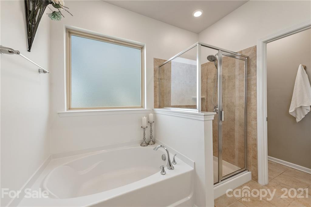 3026 Oakmere Road Waxhaw, NC 28173 - Photo 14 of 27 a bathroom with a bathtub and a shower