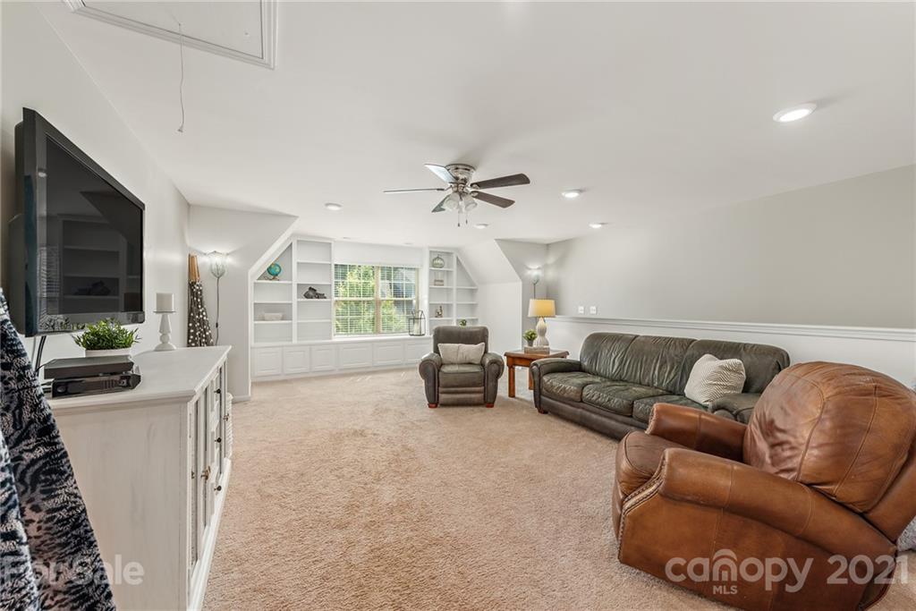 3026 Oakmere Road Waxhaw, NC 28173 - Photo 16 of 27 a living room with furniture and a flat screen tv