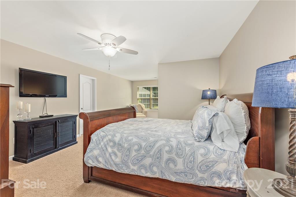 3026 Oakmere Road Waxhaw, NC 28173 - Photo 17 of 27 a bedroom with a bed and a flat screen tv