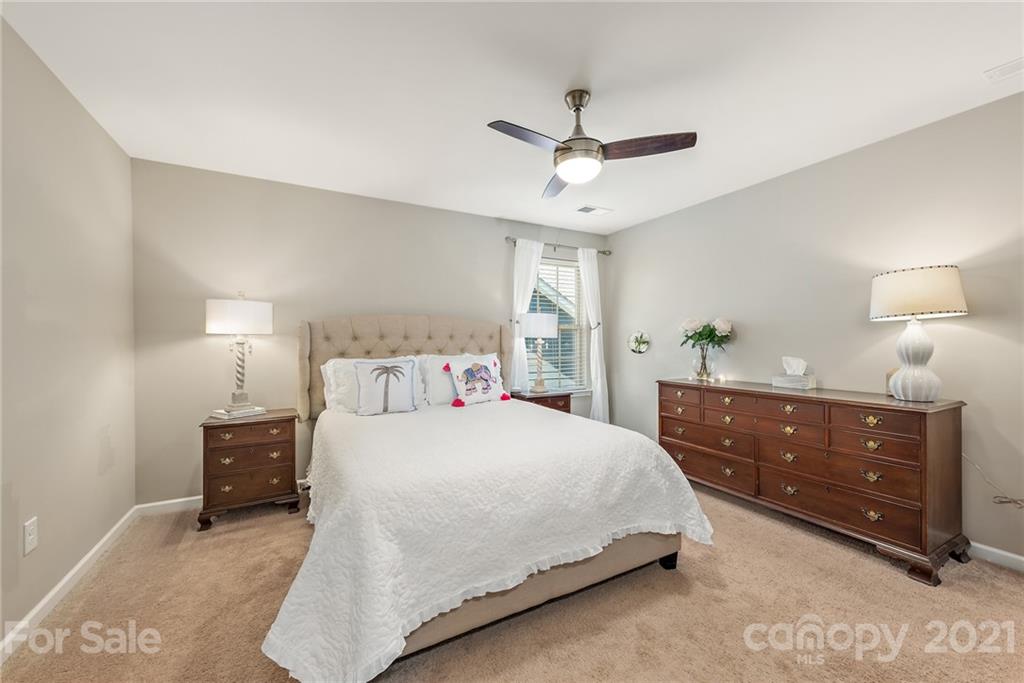 3026 Oakmere Road Waxhaw, NC 28173 - Photo 21 of 27 a bedroom with a bed window and a lamp on dresser