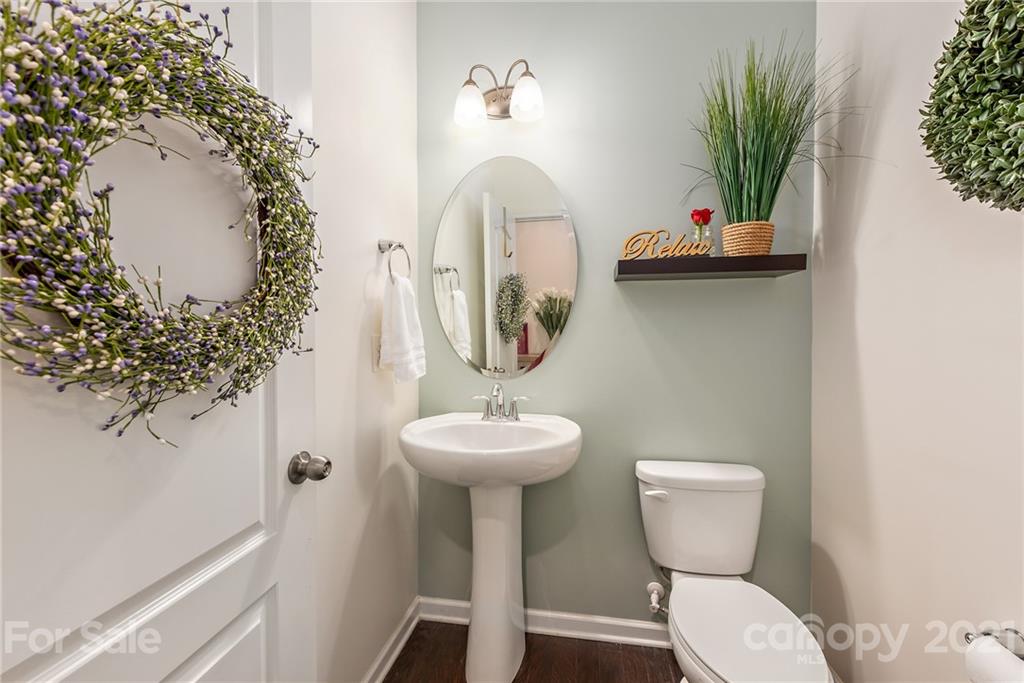 3026 Oakmere Road Waxhaw, NC 28173 - Photo 23 of 27 a bathroom with a toilet sink and mirror