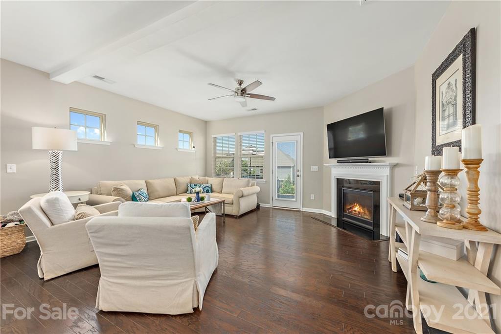3026 Oakmere Road Waxhaw, NC 28173 - Photo 4 of 27 a living room with furniture a fireplace and a flat screen tv