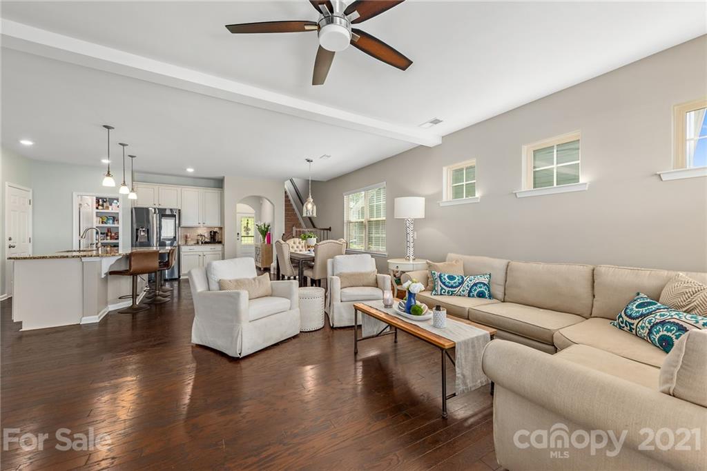 3026 Oakmere Road Waxhaw, NC 28173 - Photo 5 of 27 a living room with furniture kitchen view and a wooden floor