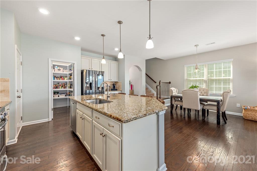 3026 Oakmere Road Waxhaw, NC 28173 - Photo 10 of 27 a kitchen with stainless steel appliances granite countertop a stove and a wooden floors