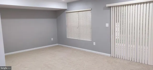 a view of a hallway with wooden floor and entryway