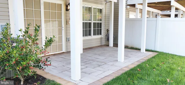 a view of a house with many windows and plants