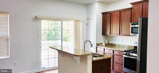a kitchen that has a sink a stove and a refrigerator