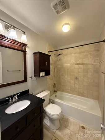 a bathroom with a toilet a sink and bathtub