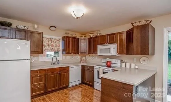 a kitchen with a sink a stove a refrigerator and cabinets