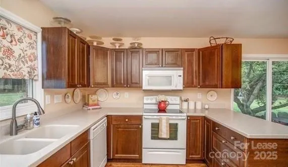 a kitchen with a sink cabinets and window