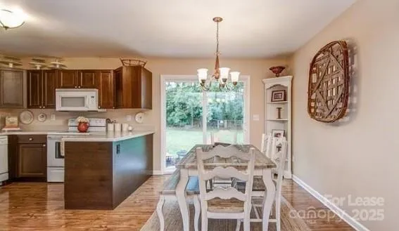 a view of a kitchen with kitchen island a counter top space and a view of living room