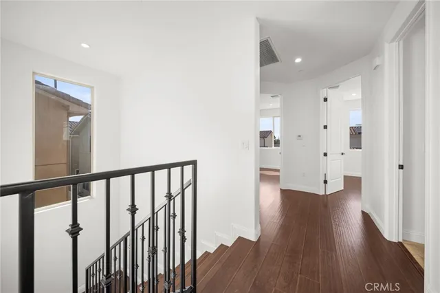 a view of a hallway with wooden floor