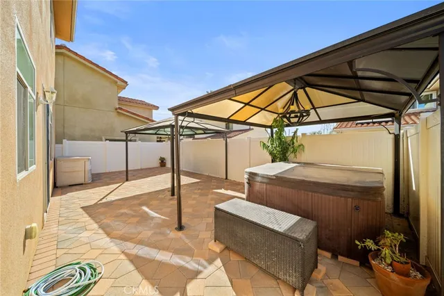 a view of a patio with table and chairs
