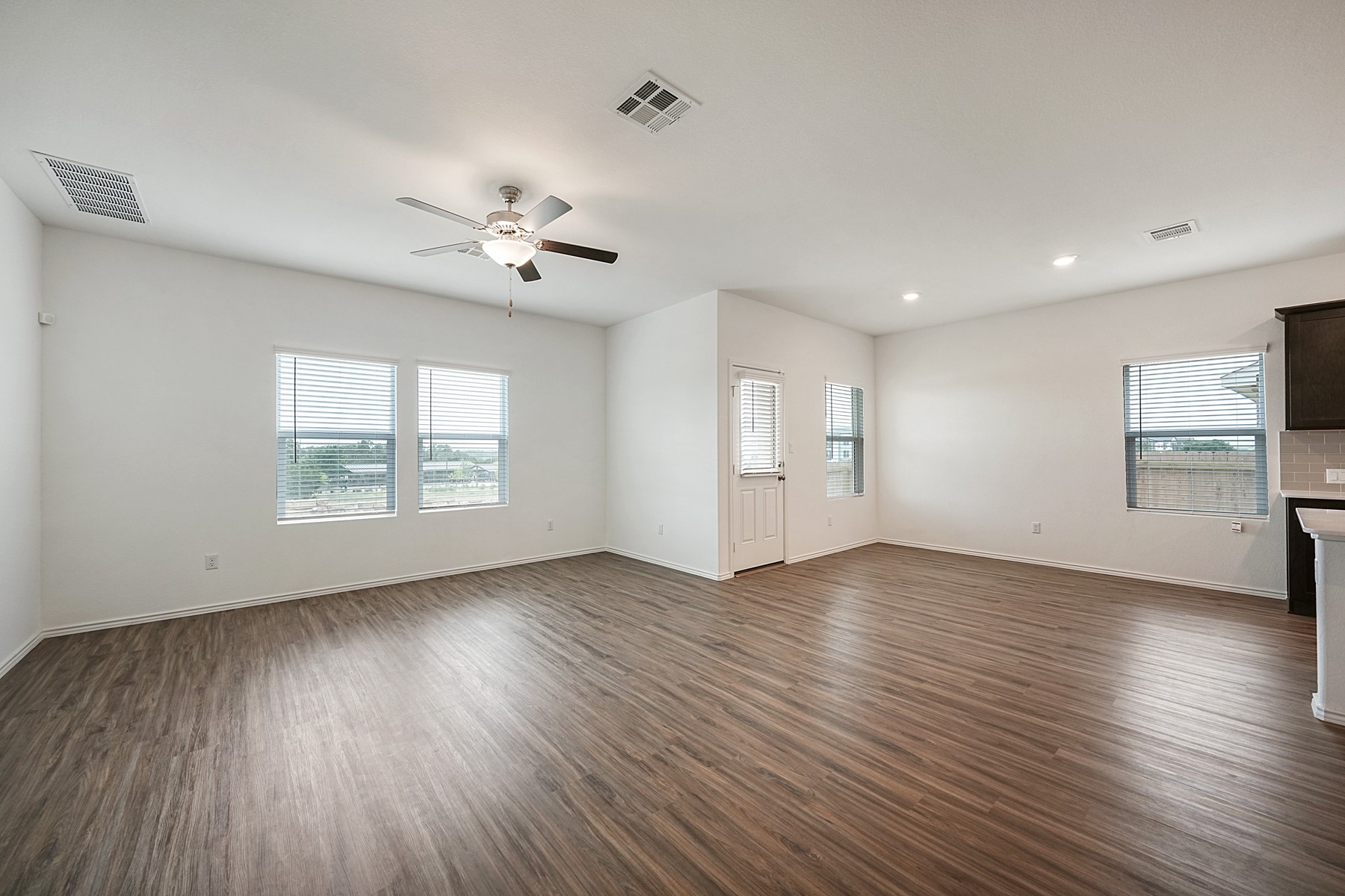 932 Mallow Road Leander, TX 78641 - Photo 22 of 34 A spacious, naturally illuminated room boasts contemporary flooring and a charming ceiling fan.