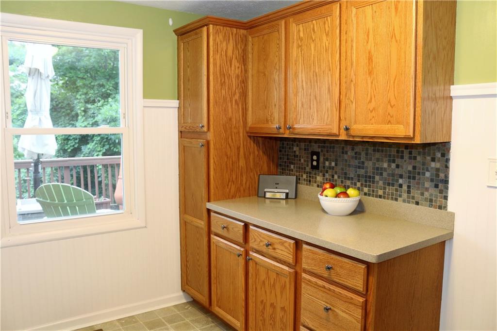 219 Shady Ridge Drive Monroeville, PA 15146 - Photo 9 of 23 Added cabinetry with even more corian countertops and stylish backsplash