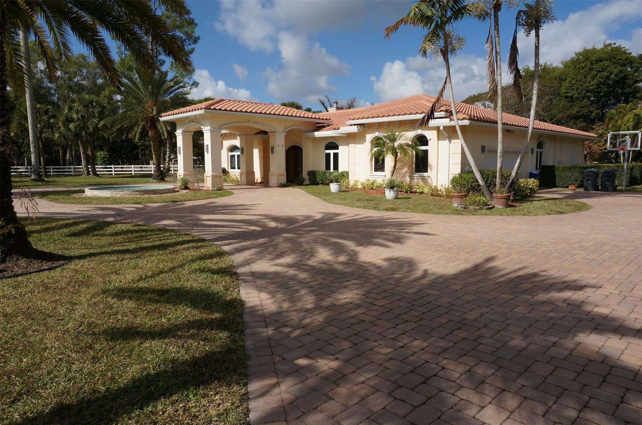 a view of a white house with a yard