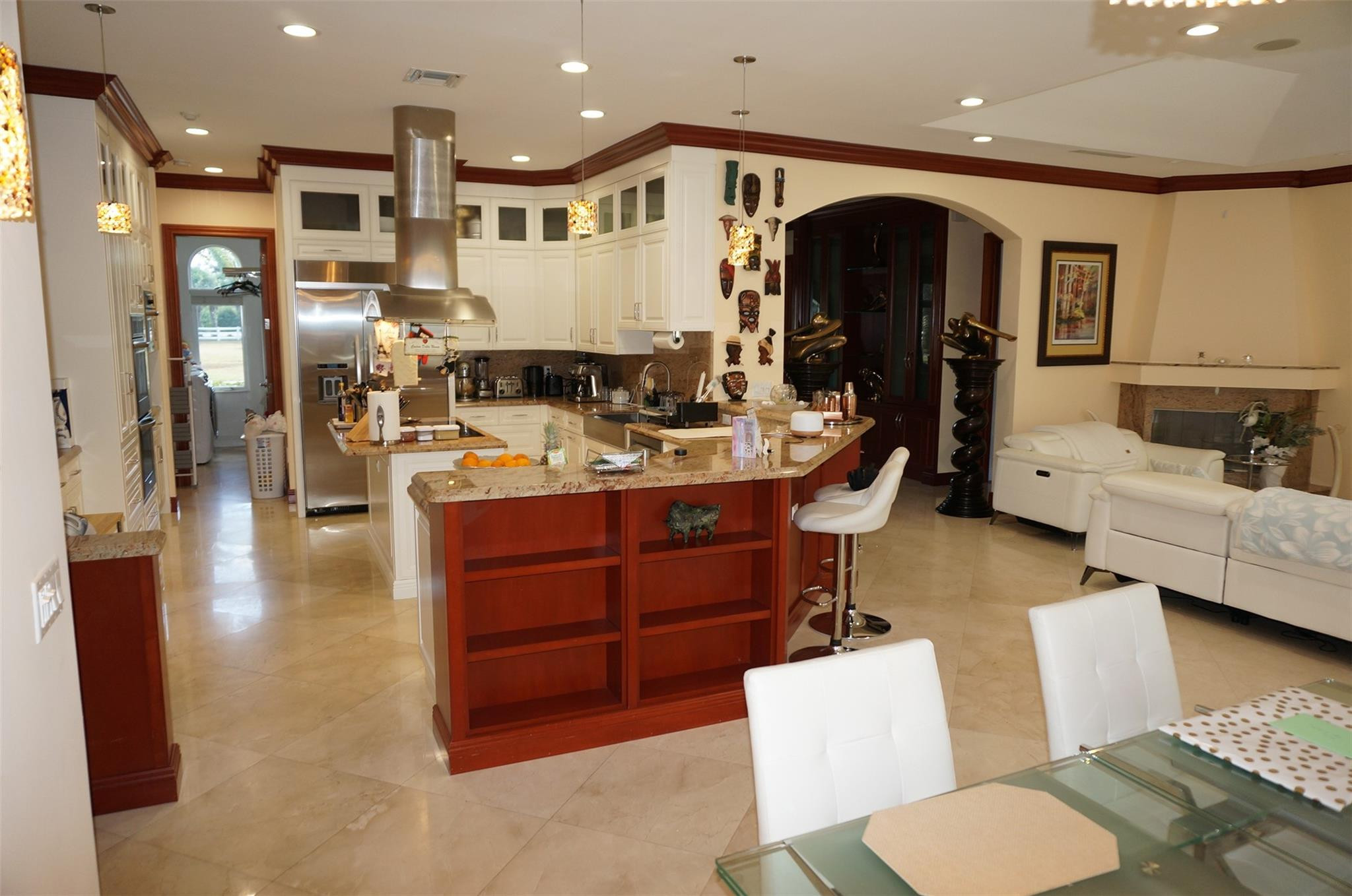 650 East Rambling Drive Wellington, FL 33414 - Photo 13 of 75 a view of living room kitchen with stainless steel appliances kitchen island furniture and a view of living room