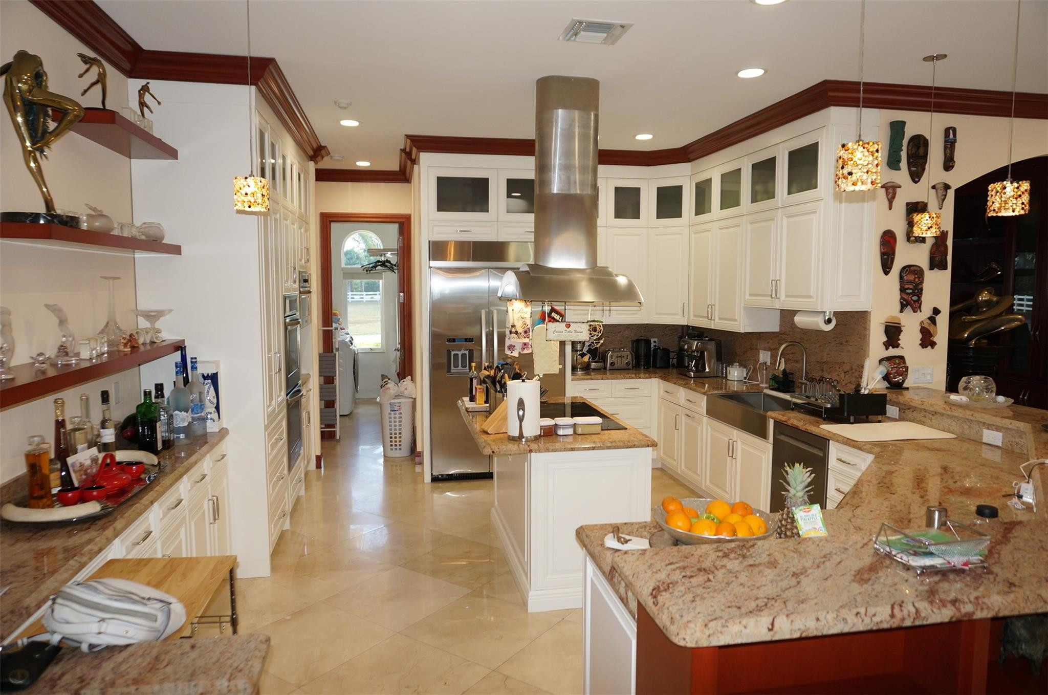 650 East Rambling Drive Wellington, FL 33414 - Photo 15 of 75 a kitchen with stainless steel appliances granite countertop a sink a stove and a refrigerator
