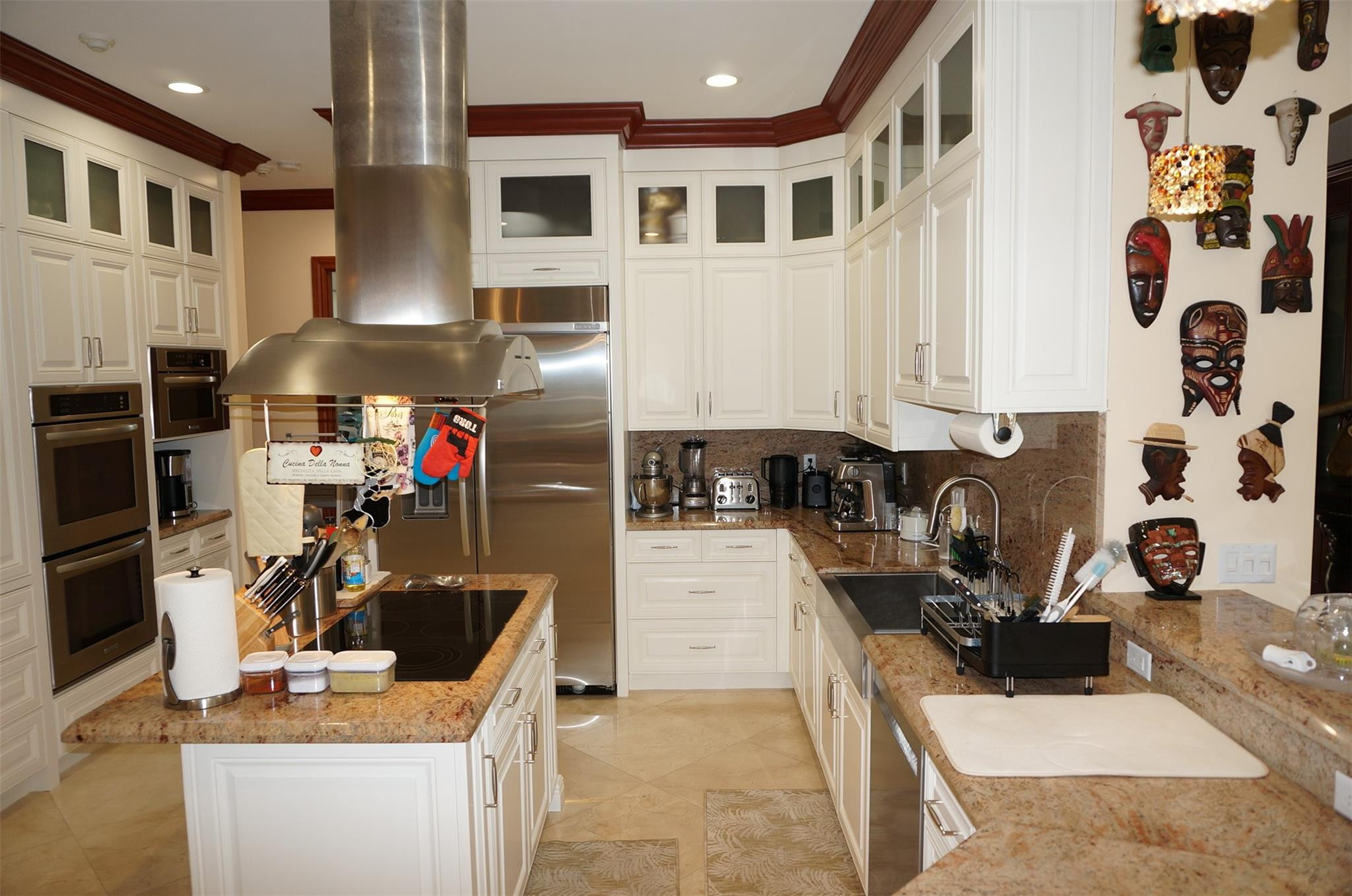 650 East Rambling Drive Wellington, FL 33414 - Photo 16 of 75 a kitchen with stainless steel appliances kitchen island granite countertop a sink stove and cabinets