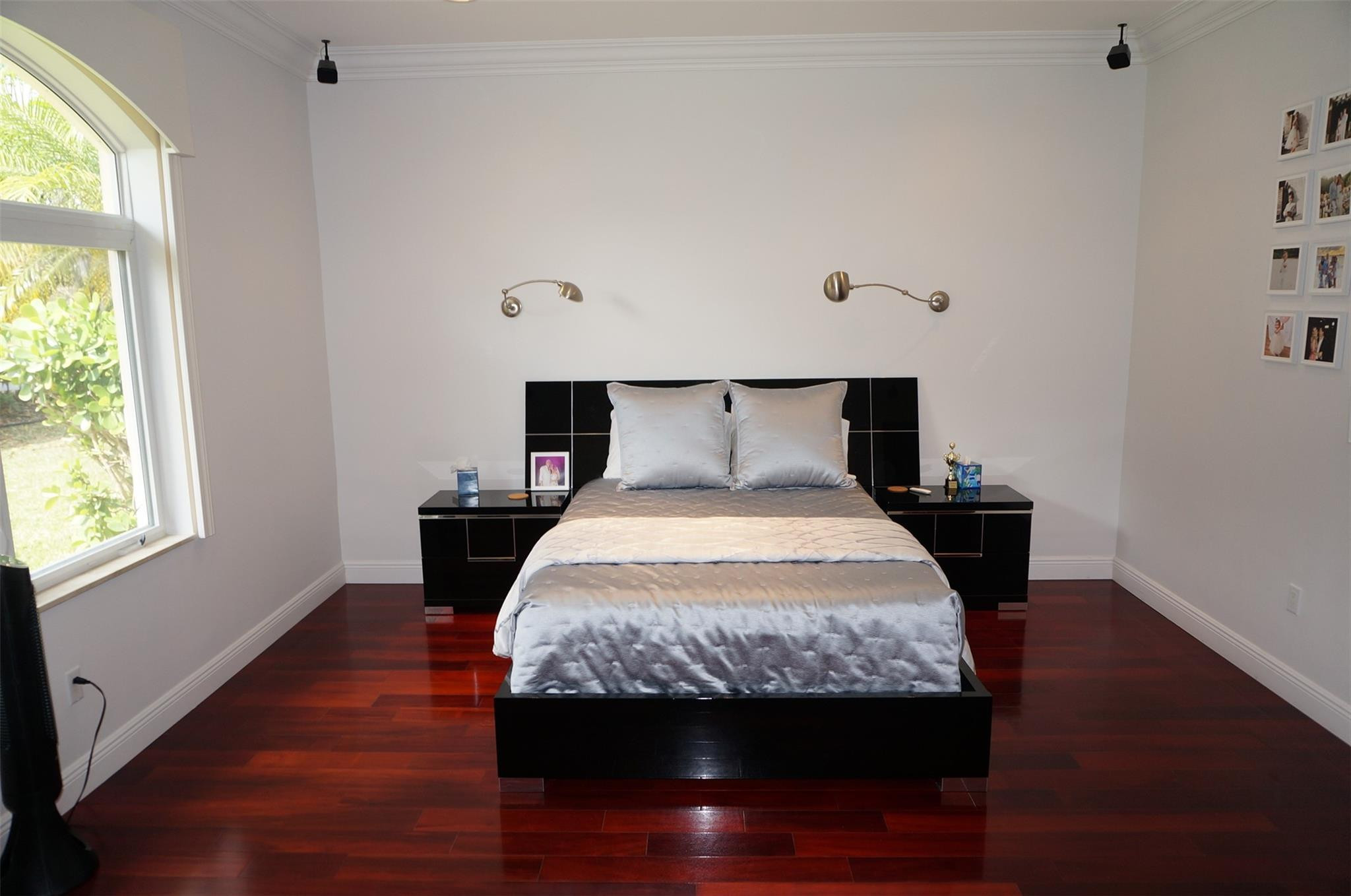 650 East Rambling Drive Wellington, FL 33414 - Photo 31 of 75 a bedroom with a bed and wooden floor