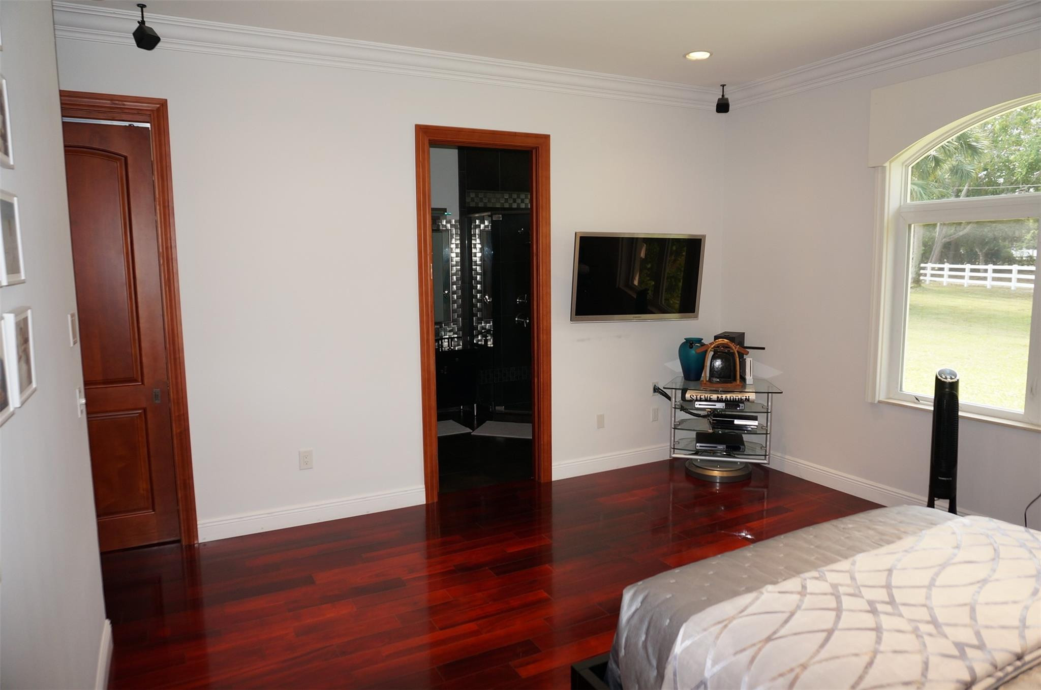 650 East Rambling Drive Wellington, FL 33414 - Photo 32 of 75 a bedroom with a bed and a flat tv screen on the dresser