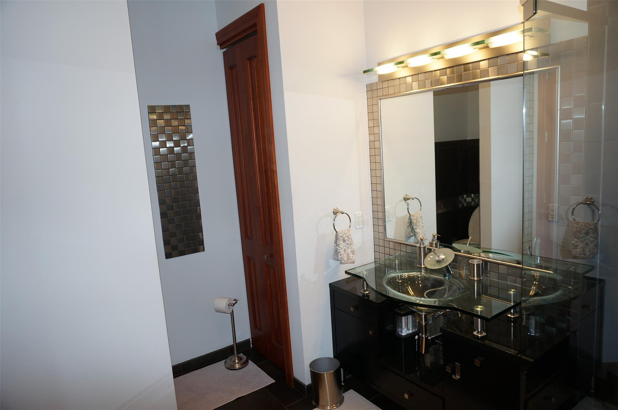 650 East Rambling Drive Wellington, FL 33414 - Photo 35 of 75 a bathroom with a sink and a mirror