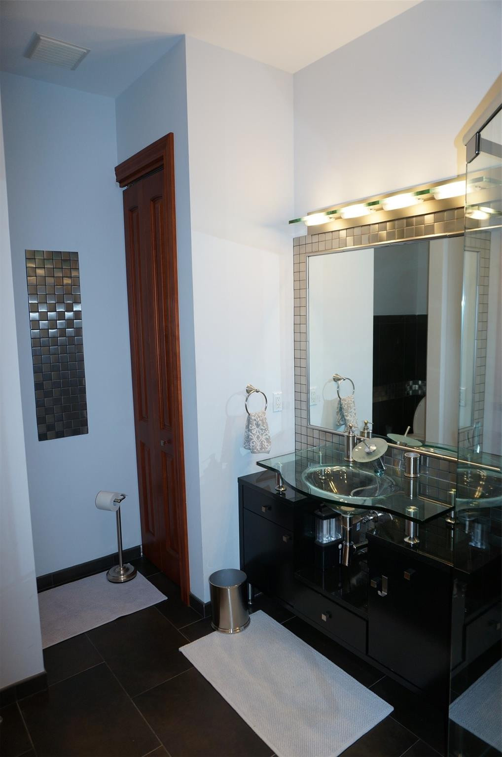 650 East Rambling Drive Wellington, FL 33414 - Photo 36 of 75 a bathroom with a sink and a mirror