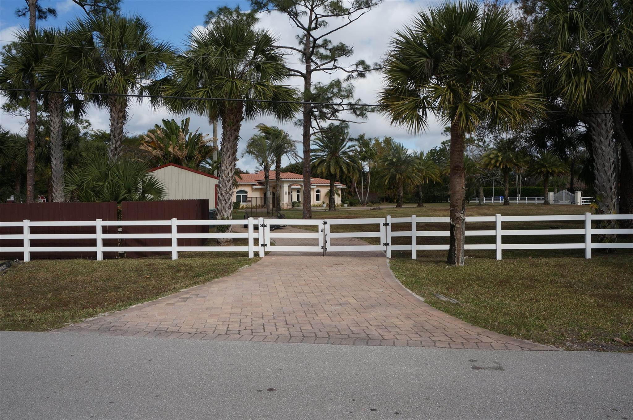 650 East Rambling Drive Wellington, FL 33414 - Photo 65 of 75 a view of a yard with large trees