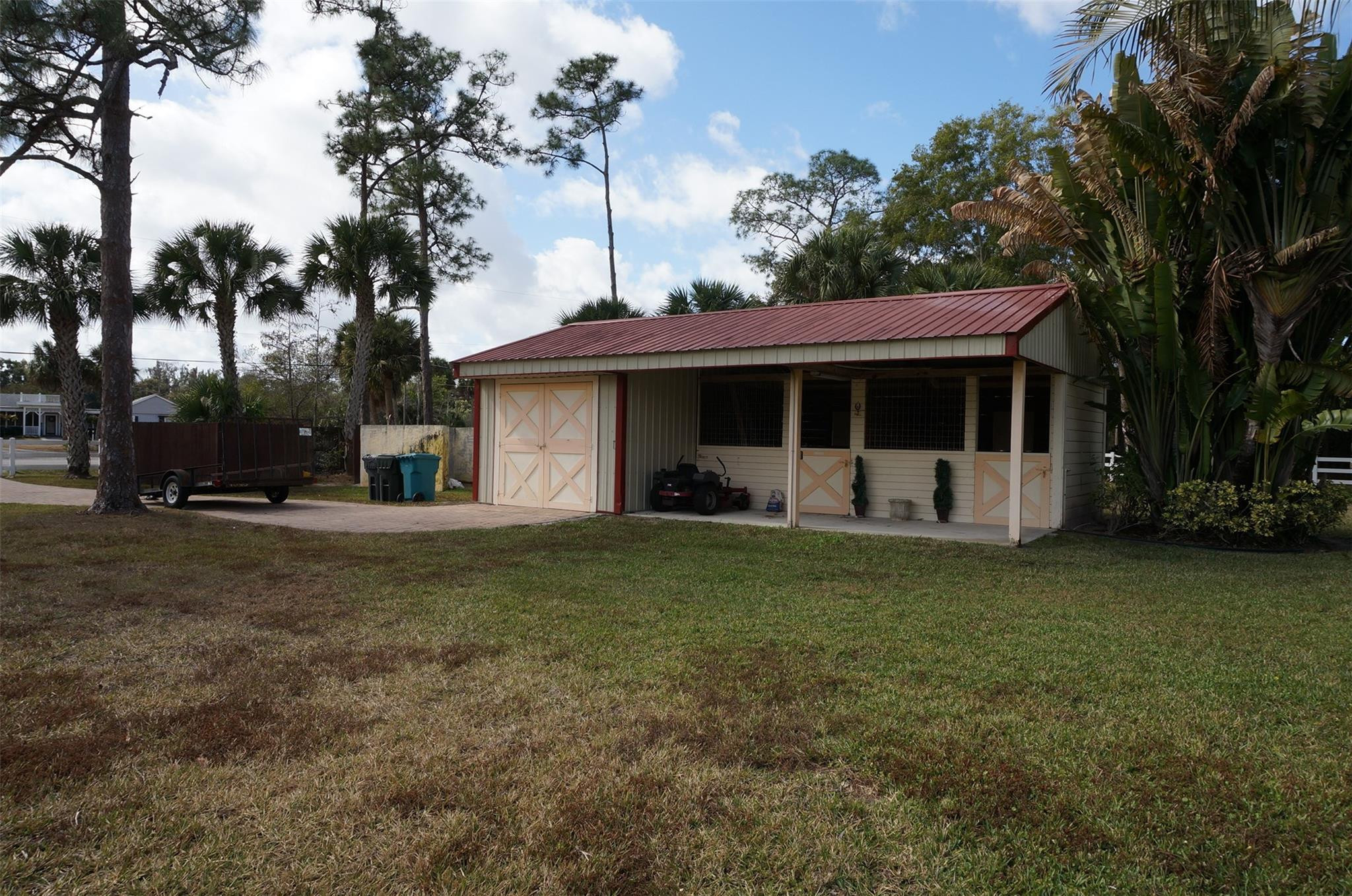 650 East Rambling Drive Wellington, FL 33414 - Photo 66 of 75 a view of a house with backyard and a tree