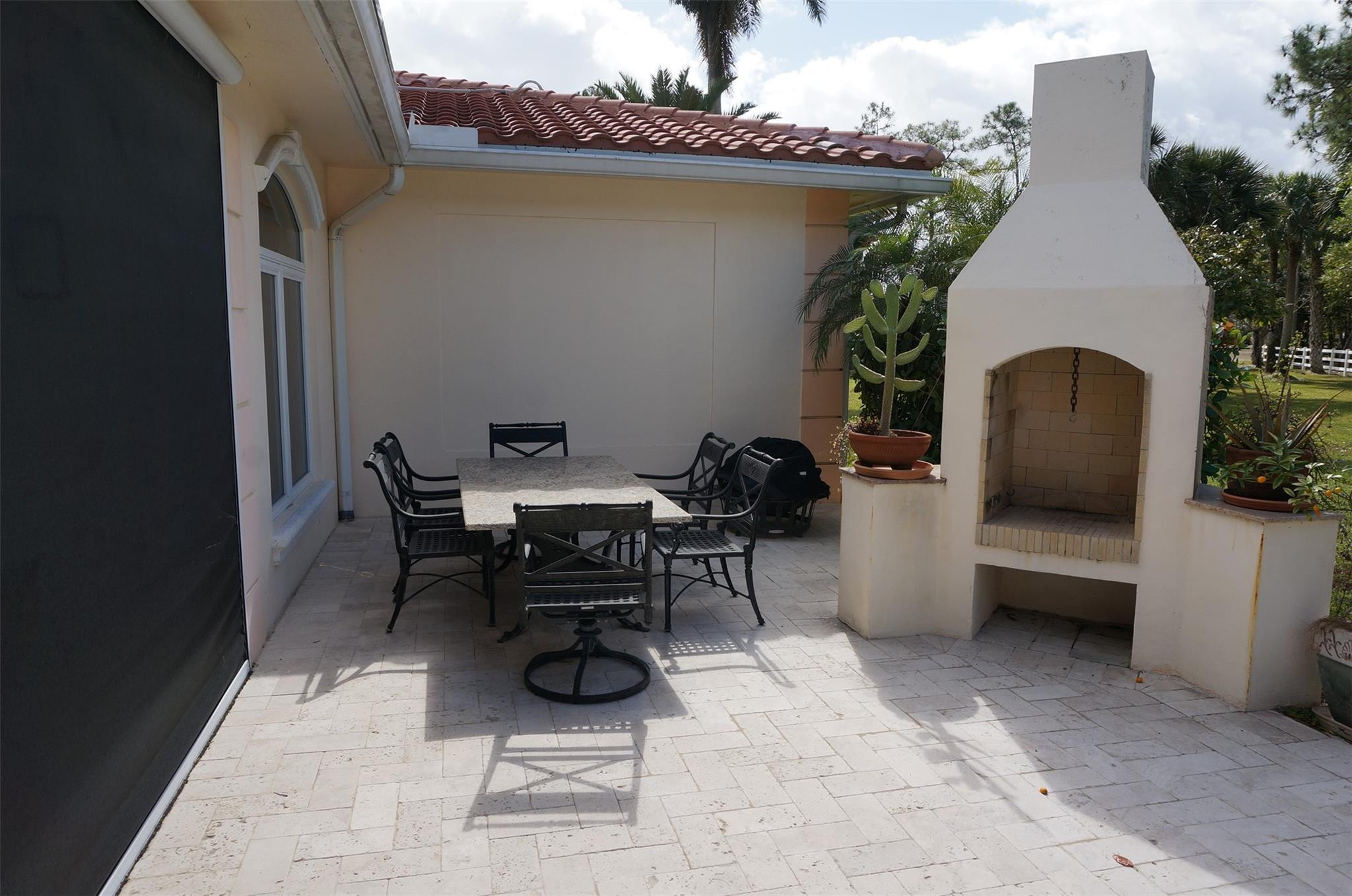 650 East Rambling Drive Wellington, FL 33414 - Photo 70 of 75 a view of a patio with table and chairs