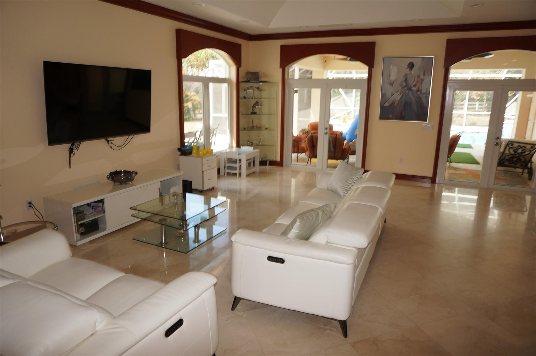 650 East Rambling Drive Wellington, FL 33414 - Photo 9 of 75 a living room with couches and a flat screen tv