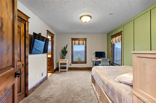 a view of a dining room with furniture and a window