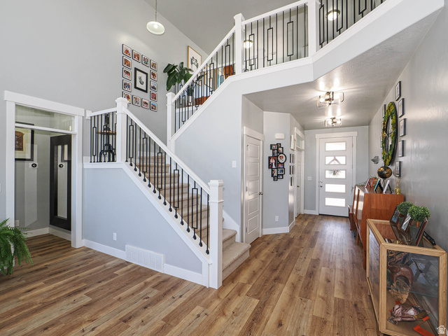 2487 Canyon Wild Road, Unit 413 Draper, UT 84020 - Photo 13 of 75 Foyer entrance with wood finished floors and a high ceiling