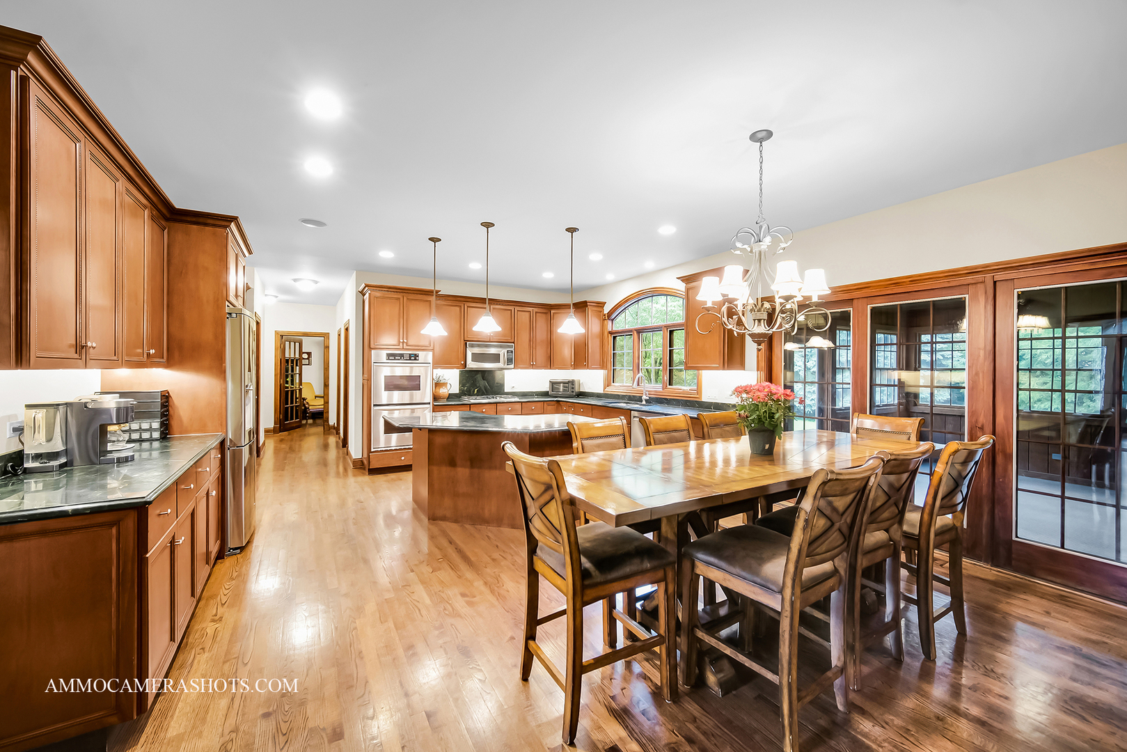 N451 Peter Road Winfield, IL 60190 - Photo 9 of 48 a dining room with stainless steel appliances kitchen island granite countertop a table chairs and a view of living room